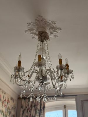 a crystal chandelier hanging from the ceiling in a room