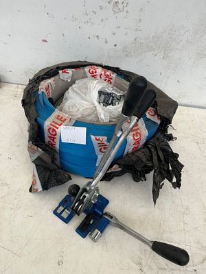 a blue bucket filled with garbage and a clamp on the floor