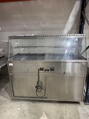 a metal counter with a glass top in a warehouse