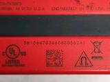 a close up of a red electronic device on a table