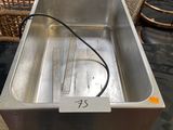 a metal pan that is sitting on top of a table
