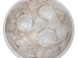 a picture of a white bowl with flowers and leaves in it