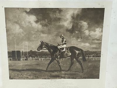 a black and white photo of a man riding a horse
