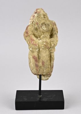 a stone statue of a woman holding a child on a black stand