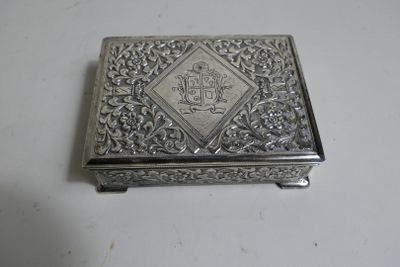 an antique silver box with a design on the lid