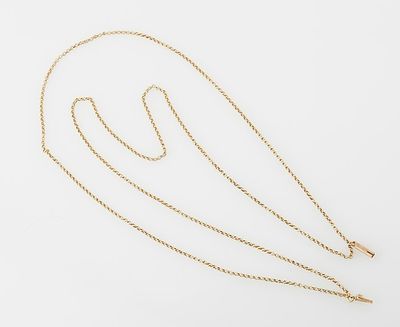 a gold necklace with a long chain that is attached to it