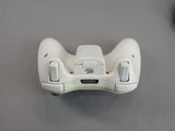 a close up of a wii controller on a table