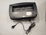 a black electric heater sitting on a table next to a remote control