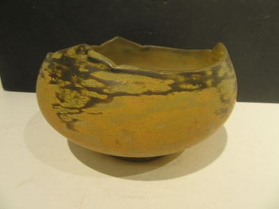 a yellow and black bowl sitting on a white table