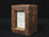 a small clock that is sitting on a black surface
