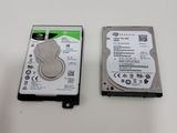 two hard drives sitting side by side on a table