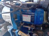 an image of a blue pump with a hose attached