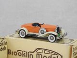 an orange toy car sitting on top of a box