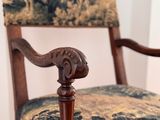 a wooden chair with a floral upholstered seat