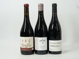 three bottles of wine sitting next to each other on a table