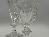 three wine glasses sitting on a white table