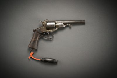 an old gun with an orange cord attached to it