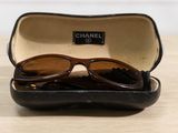 a pair of sunglasses sitting in a case on a table