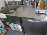 a small kitchen with a sink and a dishwasher in it