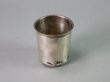 a silver cup that is sitting on a table