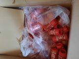 a box full of red fire extinguisors and a pair of scissors