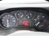 a close up of a car dashboard with a clock on it