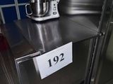 un plan de travail en acier inoxydable sur lequel se trouvent un mitigeur et une étiquette de prix