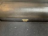 black leather case with gold lettering on it sitting on top of a table