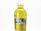 a bottle of yellow liquid sitting on top of a white surface