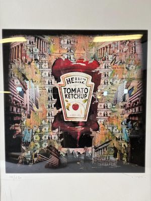 a framed picture of a ketchup advertisement on the wall