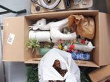 a cardboard box filled with assorted items and a stuffed animal