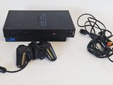 a video game console with two controllers and a charger