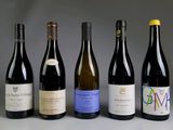 several bottles of wine are lined up in a row on a table