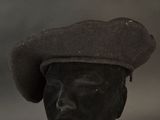 a black hat on a mannequin head on a table
