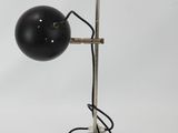 a black table lamp with a metal base and a black ball on top