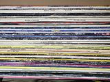 a lot of cds stacked on top of each other in a box