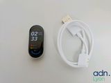 a smart watch and a usb cable connected to a charger