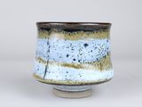 a close up of a small bowl on a white surface
