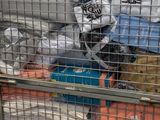 a metal cage filled with bags and other items