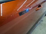 a close up of a car door handle with a sticker on it