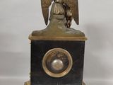 a statue of an angel sitting on top of a clock