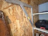 a shelf with tools on it in the corner of a room