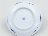 an image of a blue and white plate on a white surface