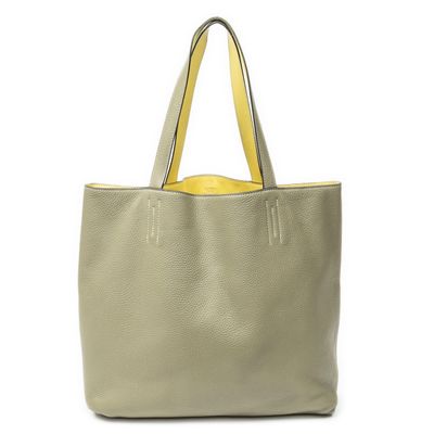 a grey and yellow tote bag with a yellow handle