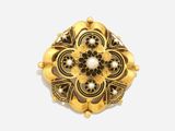 a close up of a gold broochle with pearls on it