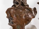 pair of bronze busts of a man and a woman on marble bases