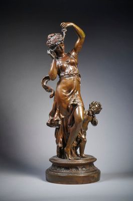 an image of a bronze statue of a woman with a dog