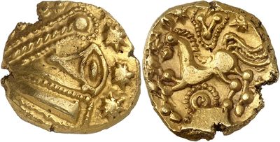 a close up of two gold coins on a white surface