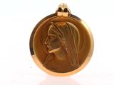 an image of a gold medal with a woman ' s face on it