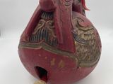an image of a red gourd with a bird on it